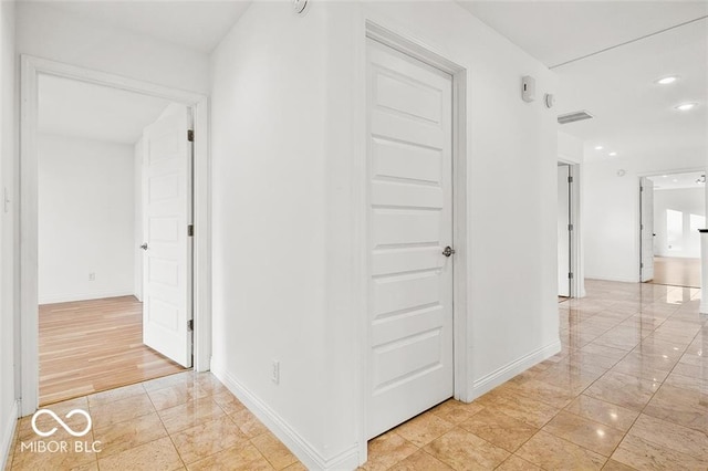 corridor with light hardwood / wood-style floors