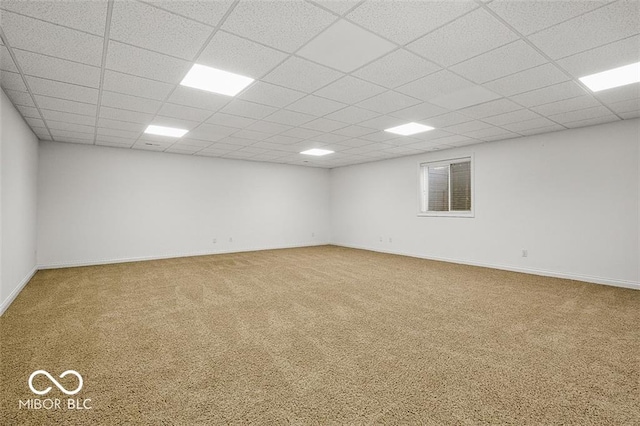 carpeted spare room featuring a paneled ceiling