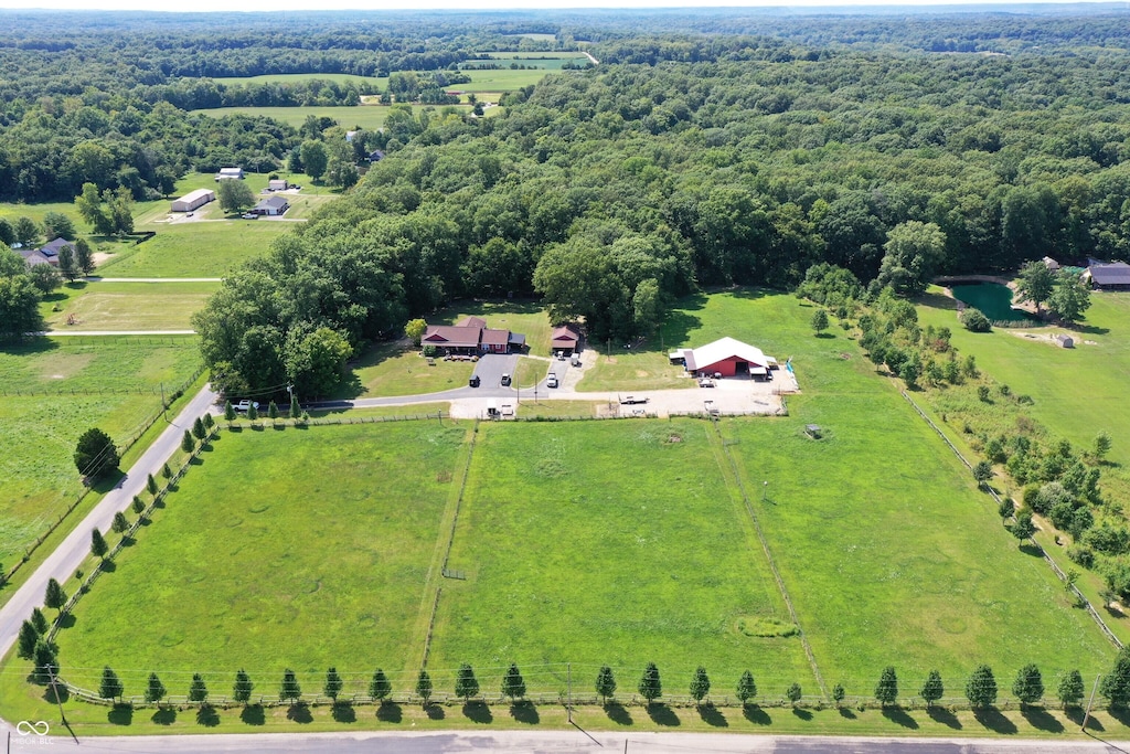 drone / aerial view featuring a rural view and a forest view