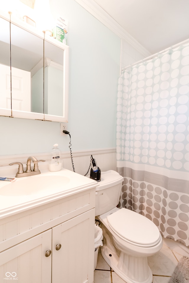 bathroom with vanity, toilet, ornamental molding, and tile patterned flooring