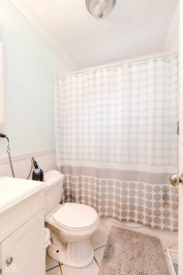 bathroom featuring toilet, ornamental molding, vanity, and tile patterned flooring