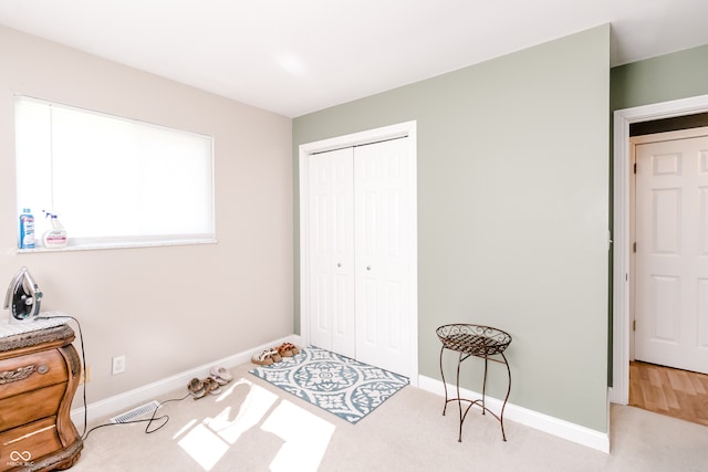 bedroom with a closet and hardwood / wood-style floors