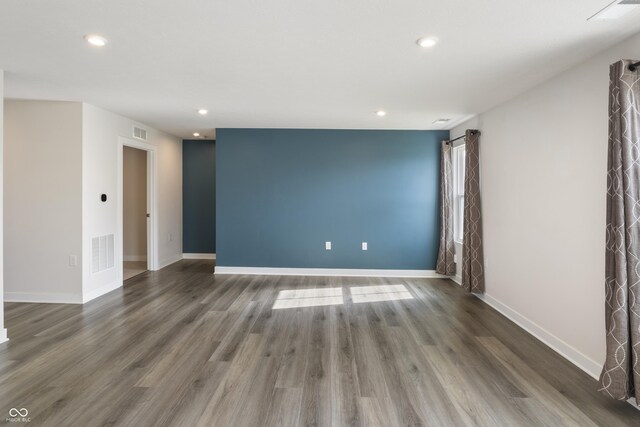 spare room with wood-type flooring