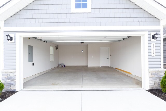 garage featuring a carport and electric panel