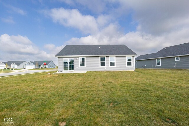 rear view of house with a lawn