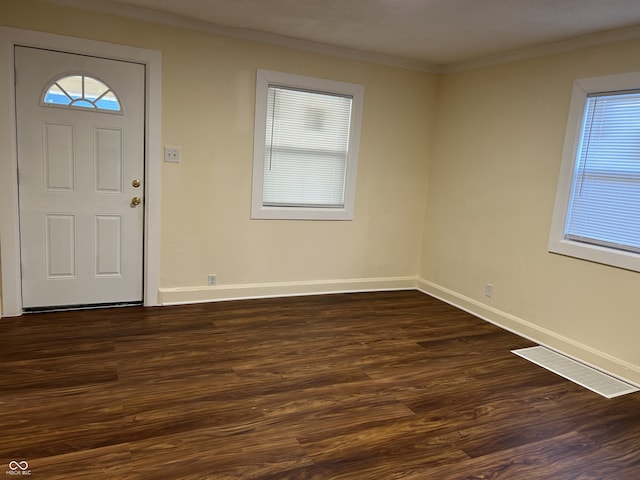 foyer with dark hardwood / wood-style floors and crown molding