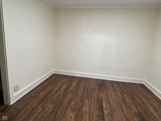 spare room with dark hardwood / wood-style flooring