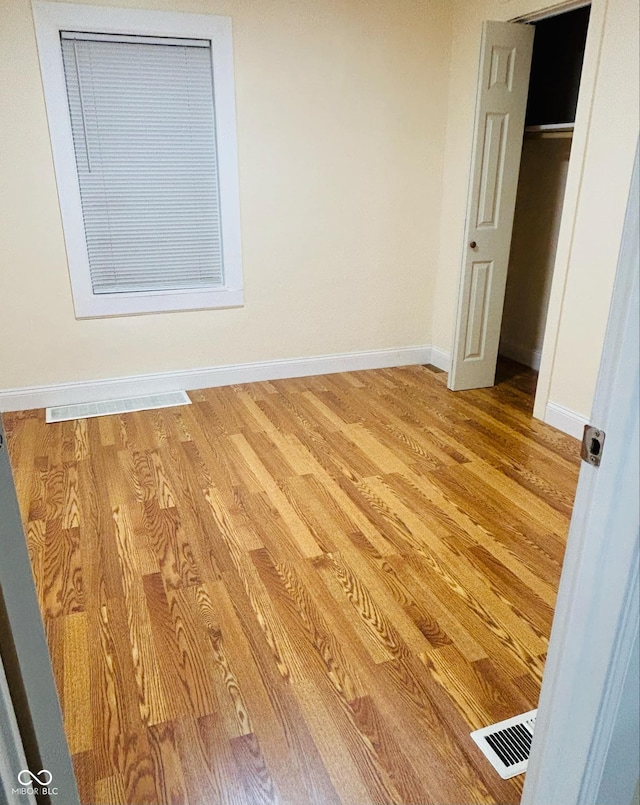 unfurnished bedroom featuring a closet and light hardwood / wood-style floors