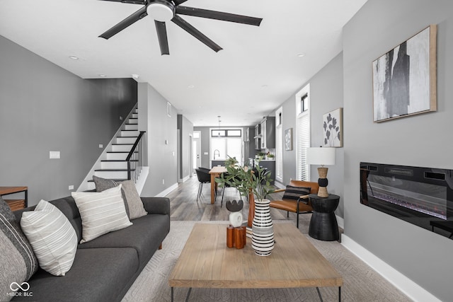 living room with ceiling fan and light hardwood / wood-style floors