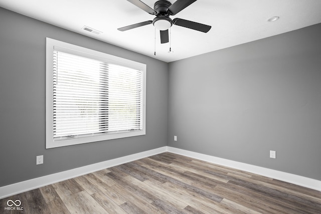 spare room with ceiling fan and hardwood / wood-style flooring