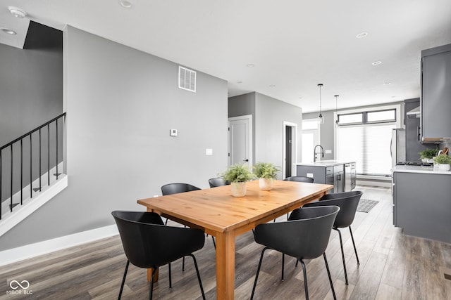 dining area featuring hardwood / wood-style floors and sink