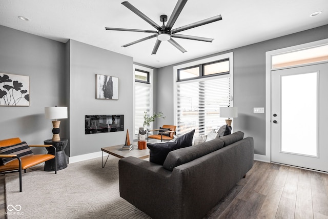 living room featuring hardwood / wood-style floors and ceiling fan