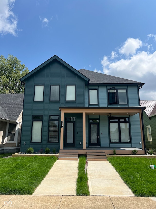 view of front facade with covered porch and a front lawn