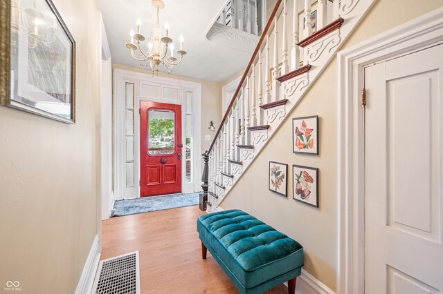 entryway with an inviting chandelier and hardwood / wood-style floors