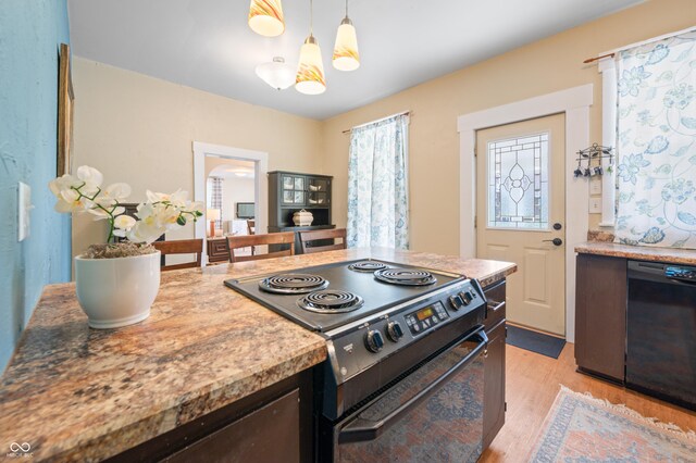 kitchen featuring black appliances, light hardwood / wood-style flooring, and pendant lighting