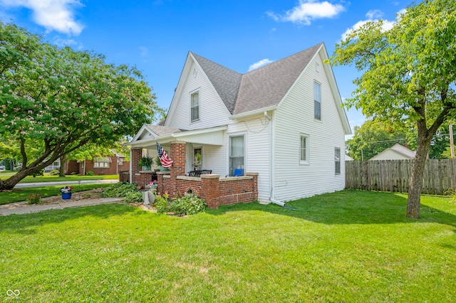 view of front of home featuring covered porch and a front yard