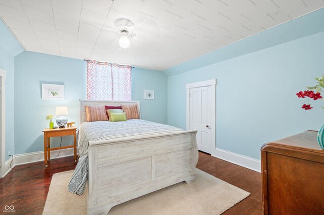 bedroom with dark hardwood / wood-style floors