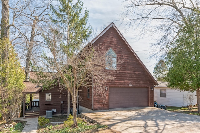 view of front of home featuring a garage and central air condition unit