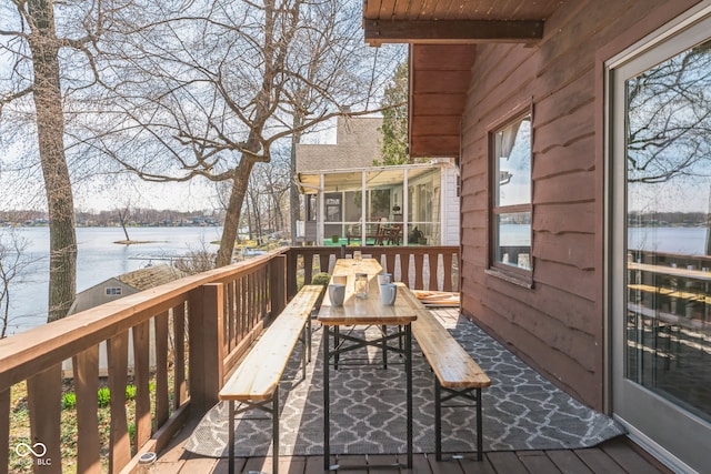 wooden terrace featuring a water view