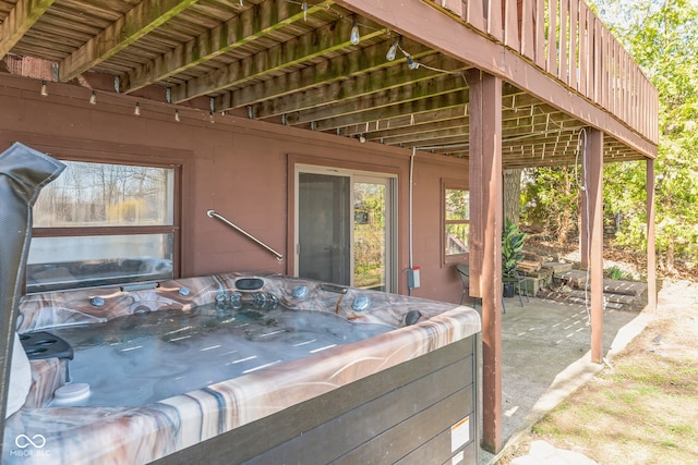 wooden terrace with a hot tub