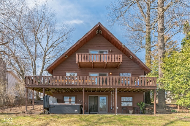 rear view of property featuring a deck and a yard