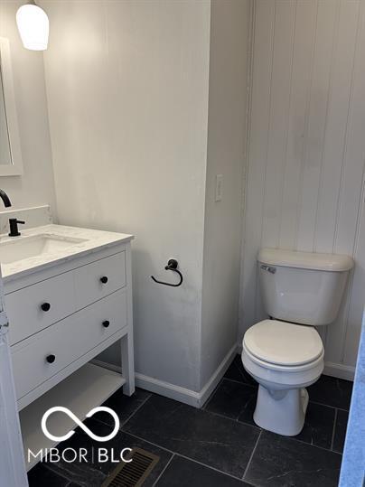 bathroom featuring toilet, tile patterned floors, and vanity