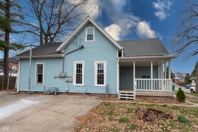 back of property featuring covered porch