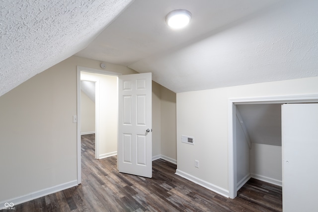 bonus room featuring a textured ceiling, vaulted ceiling, and hardwood / wood-style flooring