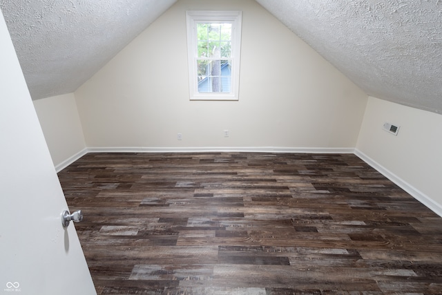 bonus room featuring a textured ceiling, lofted ceiling, and hardwood / wood-style floors