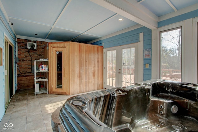 interior space with french doors, wood walls, and tile patterned floors