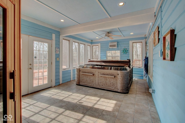 interior space with ceiling fan and a wall unit AC