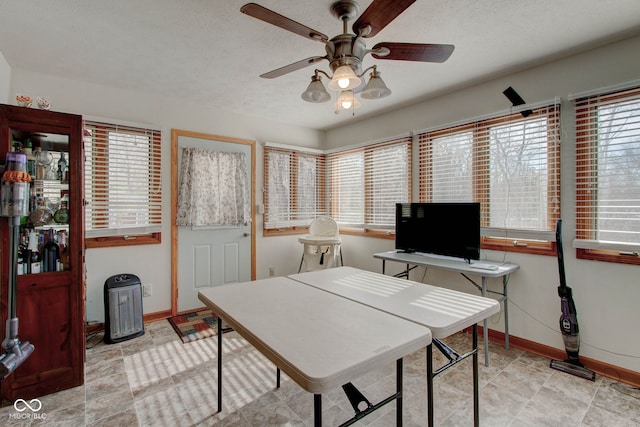 office with a textured ceiling and ceiling fan