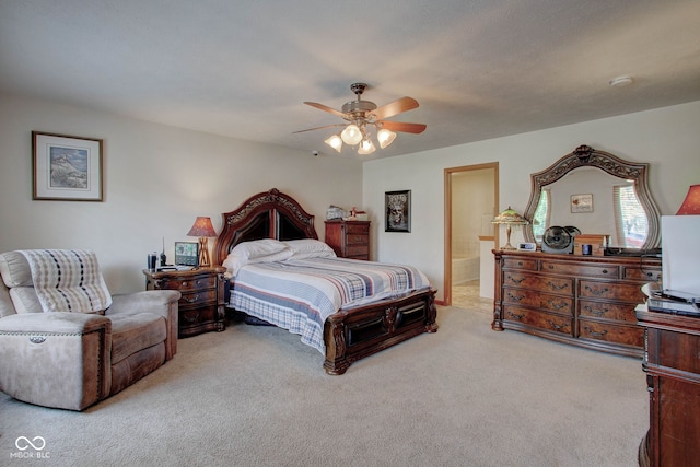 bedroom featuring ensuite bath, ceiling fan, and carpet flooring