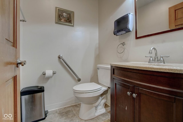 bathroom featuring tile patterned flooring, toilet, and vanity