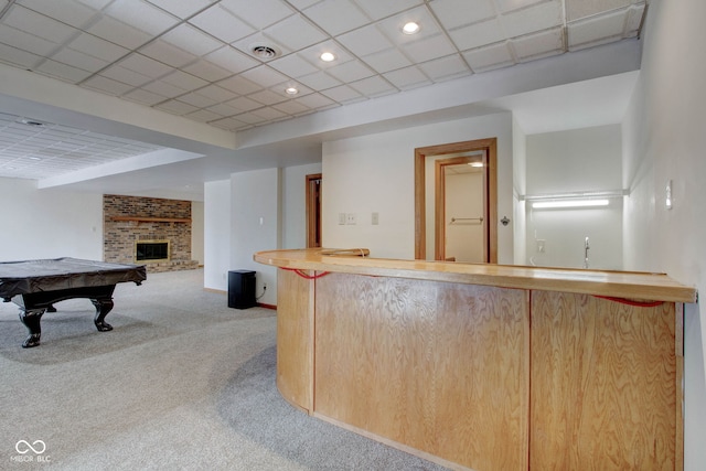 interior space featuring bar, billiards, and a brick fireplace