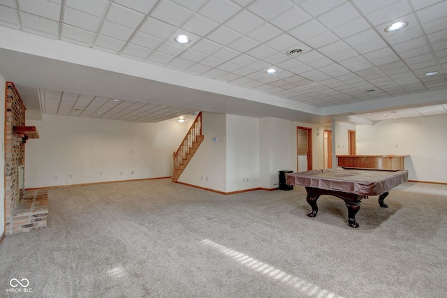 rec room featuring light carpet, billiards, a brick fireplace, and a paneled ceiling