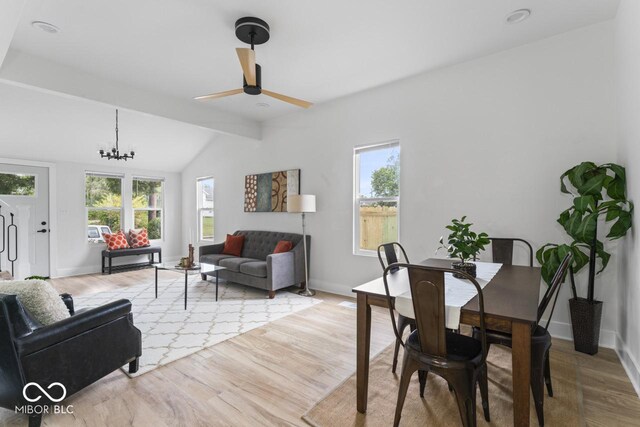 1046 Dawson St, Indianapolis, IN 46203 - dining space featuring lofted ceiling with beams, a wealth of natural light, wood finished floors, and ceiling fan with notable chandelier