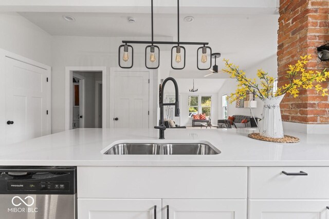 1046 Dawson St, Indianapolis, IN 46203 - kitchen with stainless steel dishwasher, white cabinetry, light countertops, and a sink