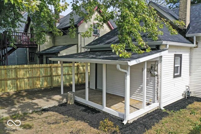 1046 Dawson St, Indianapolis, IN 46203 - view of home's exterior featuring a shingled roof and fence