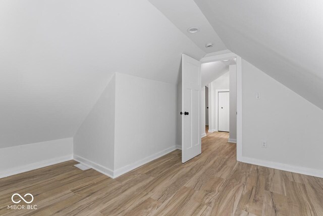 1046 Dawson St, Indianapolis, IN 46203 - bonus room featuring baseboards, lofted ceiling, and wood finished floors