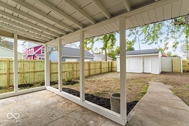 1046 Dawson St, Indianapolis, IN 46203 - view of yard with a fenced backyard, a shed, an outbuilding, and a patio area