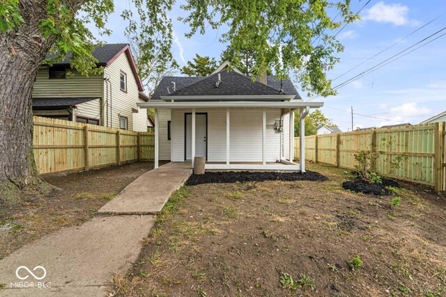 1046 Dawson St, Indianapolis, IN 46203 - exterior space with a shingled roof, a porch, and fence private yard