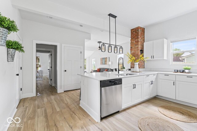 1046 Dawson St, Indianapolis, IN 46203 - kitchen featuring a peninsula, dishwasher, white cabinetry, a sink, and light wood-style floors