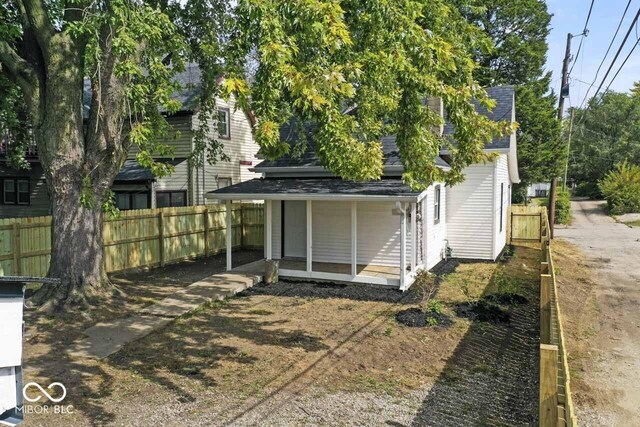1046 Dawson St, Indianapolis, IN 46203 - rear view of house featuring a shingled roof and fence