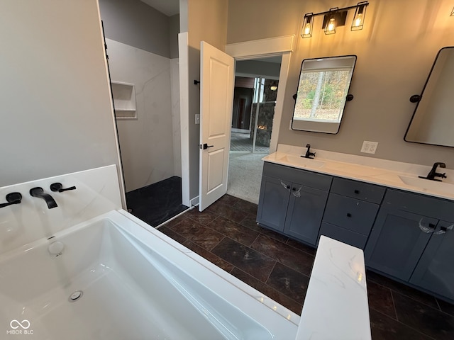 bathroom featuring a washtub and vanity