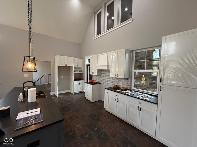 3380 N Pine Song Dr, Martinsville, IN 46151 - kitchen with a sink, backsplash, high vaulted ceiling, dark countertops, and white cabinets