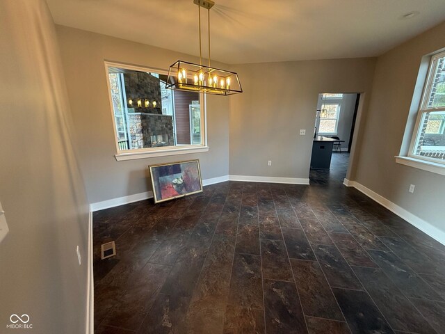 3380 N Pine Song Dr, Martinsville, IN 46151 - unfurnished dining area with hardwood / wood-style floors, a chandelier, and baseboards