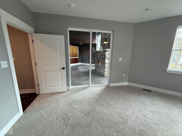 3380 N Pine Song Dr, Martinsville, IN 46151 - unfurnished bedroom featuring carpet flooring and a warm lit fireplace