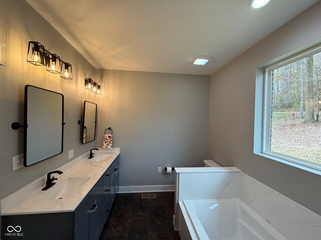 bathroom with tile patterned flooring, vanity, and a bathtub