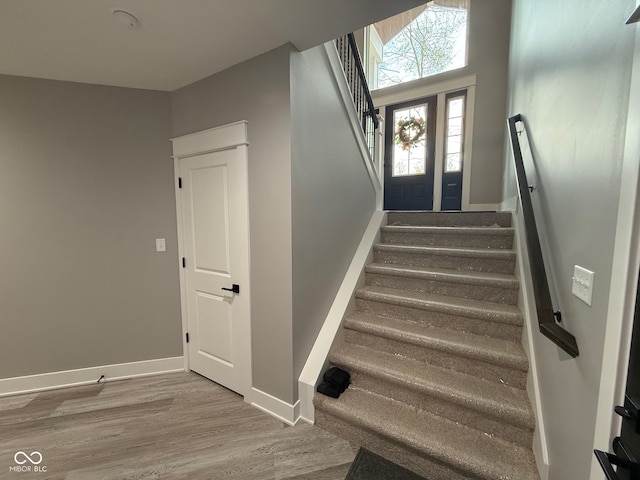 staircase with hardwood / wood-style floors